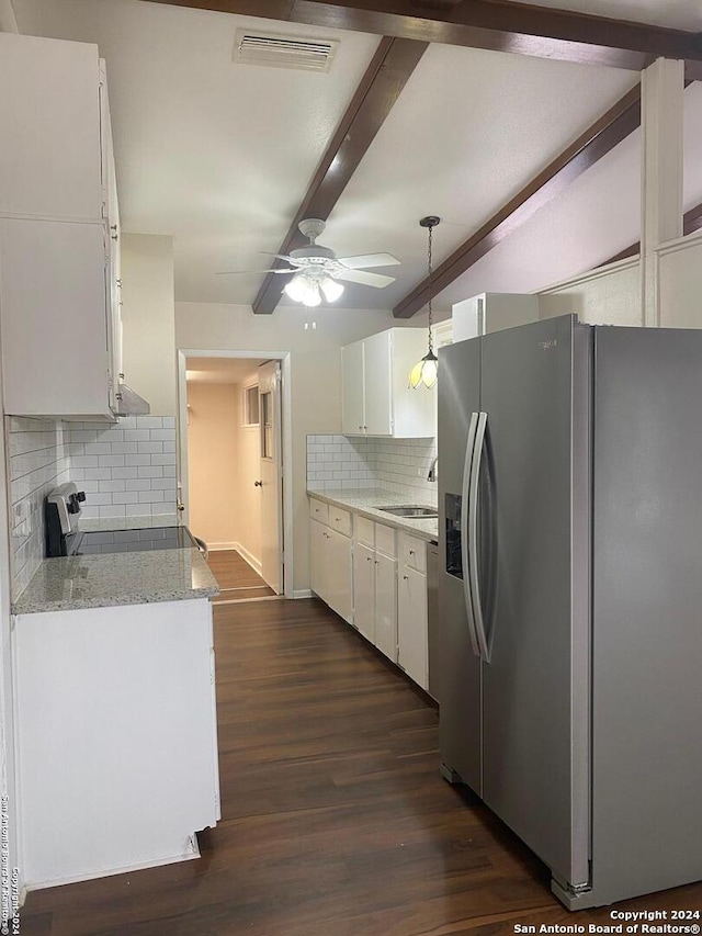 kitchen with light stone counters, decorative backsplash, beam ceiling, white cabinetry, and appliances with stainless steel finishes