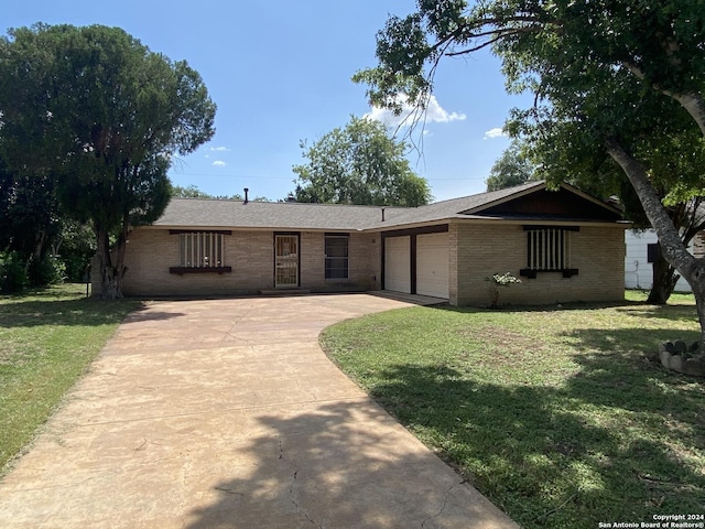 ranch-style home with a front lawn and a garage