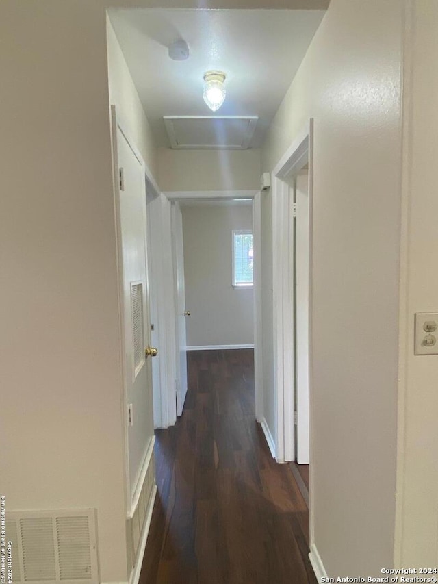 corridor with dark hardwood / wood-style flooring