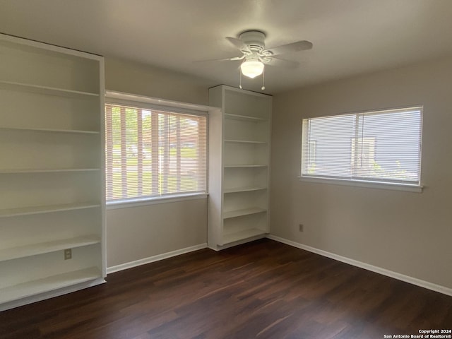 unfurnished bedroom with ceiling fan and dark hardwood / wood-style floors