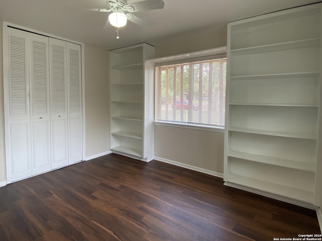 unfurnished bedroom featuring ceiling fan, dark hardwood / wood-style flooring, and a closet