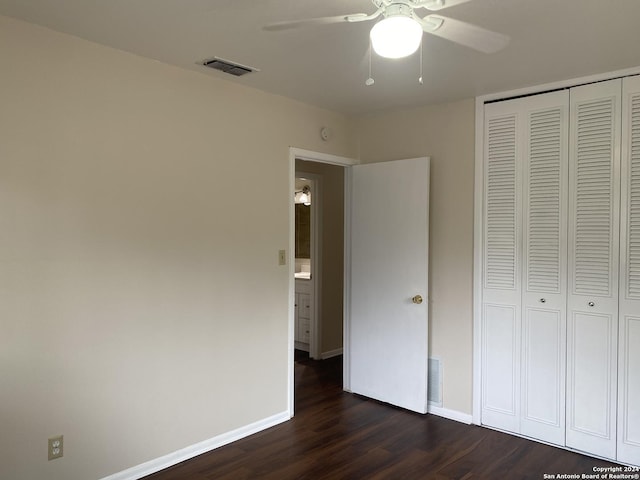 unfurnished bedroom featuring ceiling fan, dark hardwood / wood-style flooring, and a closet