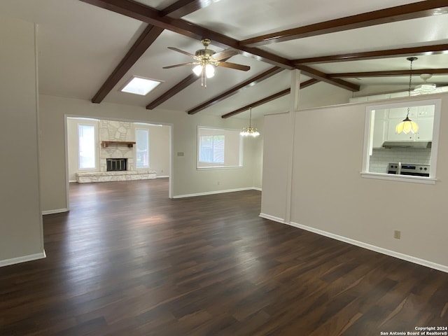 unfurnished living room with a fireplace, ceiling fan, lofted ceiling with beams, and dark hardwood / wood-style floors