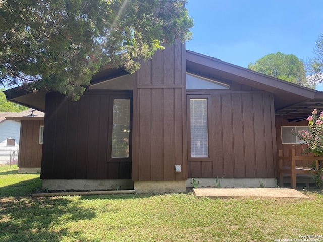 view of side of home featuring a lawn