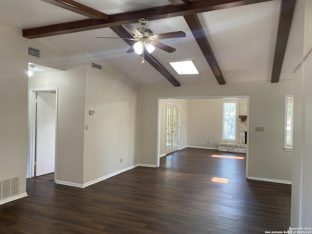 interior space featuring a fireplace, ceiling fan, vaulted ceiling with beams, and dark wood-type flooring