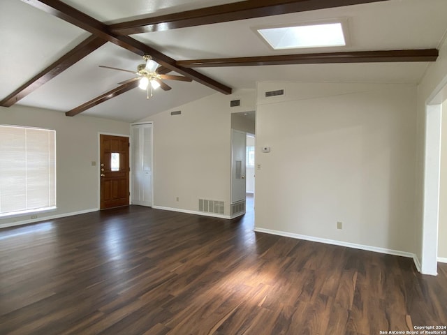 unfurnished living room featuring ceiling fan, vaulted ceiling with skylight, and dark hardwood / wood-style floors