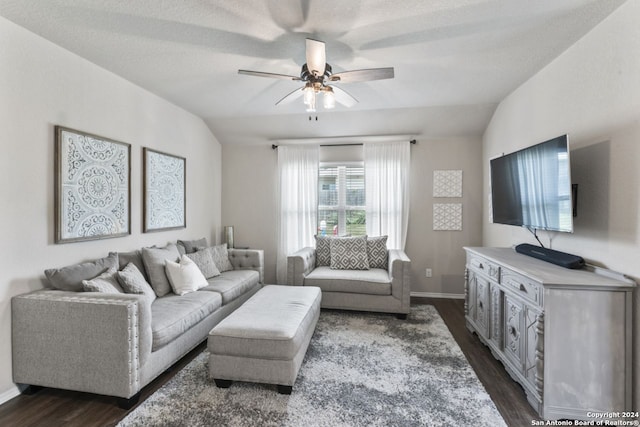 living room featuring ceiling fan, a textured ceiling, dark hardwood / wood-style floors, and lofted ceiling