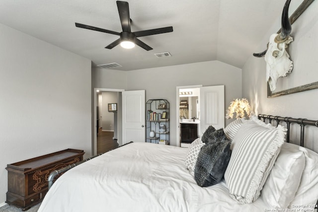 bedroom featuring ceiling fan, ensuite bathroom, and lofted ceiling