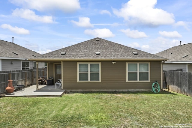 rear view of house featuring a yard and a patio