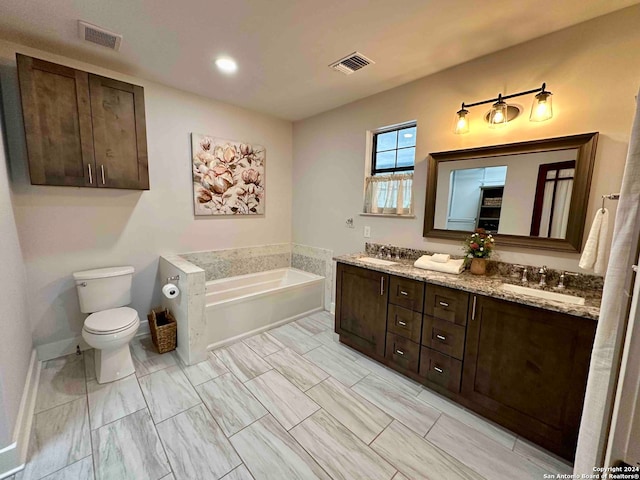 bathroom with dual vanity, tile patterned floors, a tub, and toilet