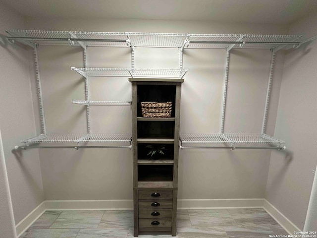 spacious closet featuring light tile patterned flooring