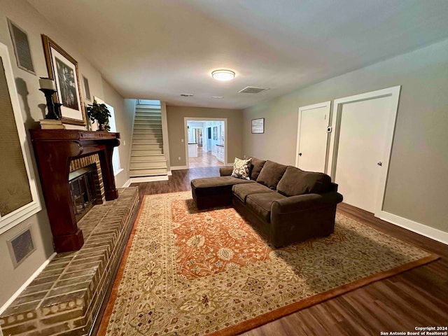 living room featuring a fireplace and dark hardwood / wood-style flooring