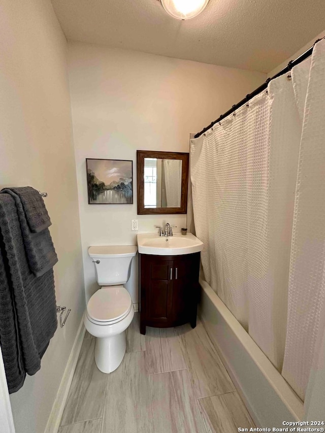 full bathroom with a textured ceiling, toilet, vanity, tile patterned floors, and shower / bath combo