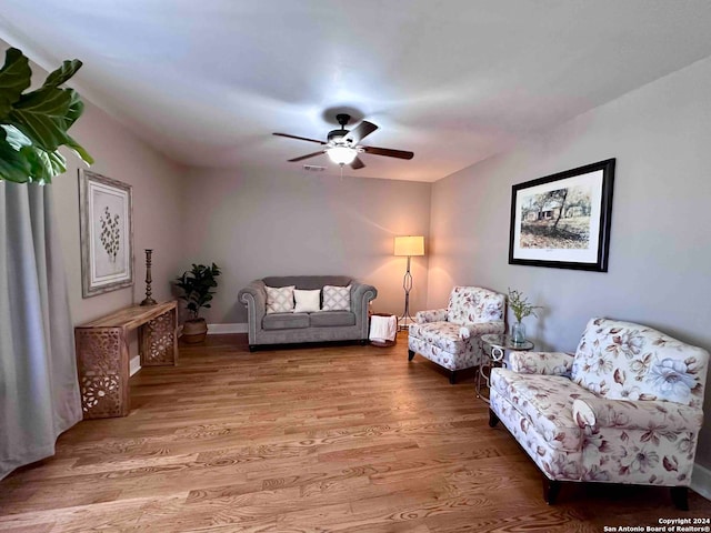 living room with hardwood / wood-style floors and ceiling fan