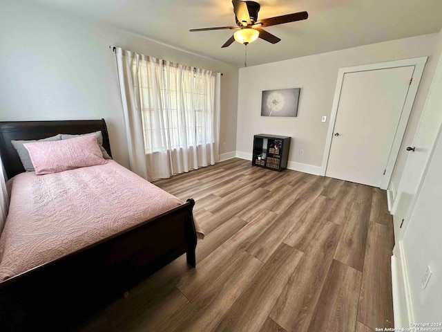 bedroom with wood-type flooring and ceiling fan