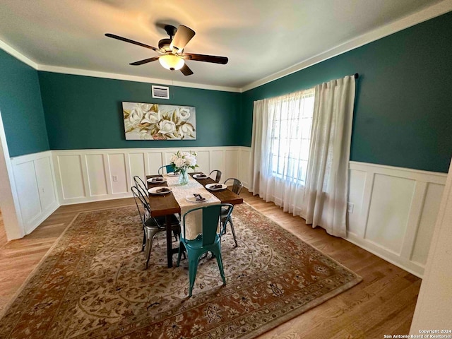 dining space featuring ornamental molding, ceiling fan, and hardwood / wood-style floors