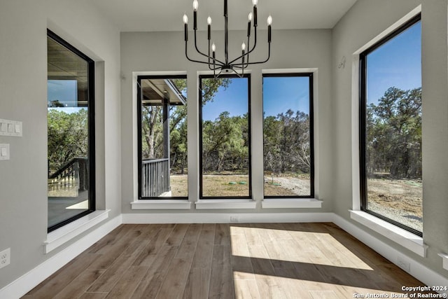 unfurnished sunroom featuring a notable chandelier