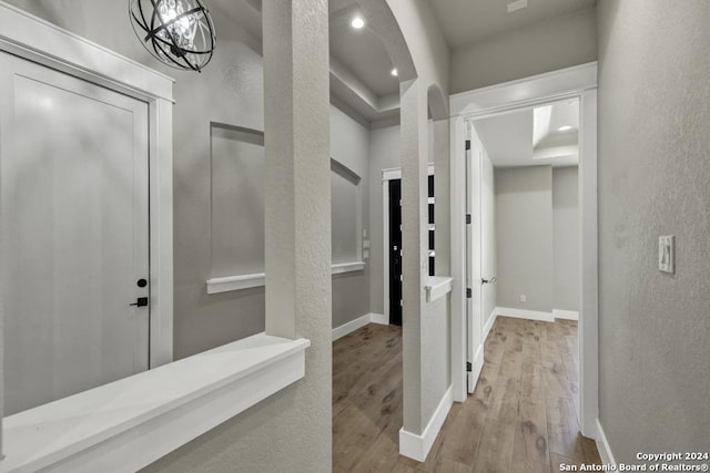 corridor with light hardwood / wood-style flooring