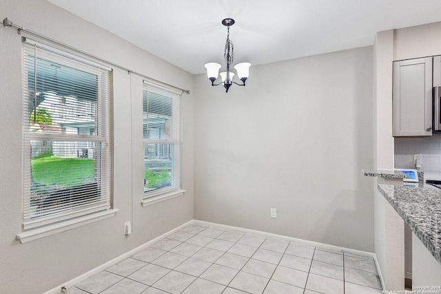 14343 Judson Rd Unit 803, San Antonio, TX 78233 - unfurnished dining area featuring plenty of natural light, a chandelier, light tile patterned floors, and baseboards