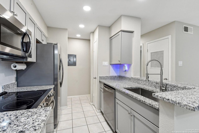 14343 Judson Rd Unit 803, San Antonio, TX 78233 - kitchen with appliances with stainless steel finishes, a sink, gray cabinets, recessed lighting, and light stone counters