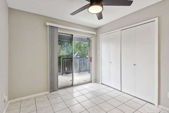 unfurnished bedroom with access to exterior, ceiling fan, light tile patterned flooring, and a closet