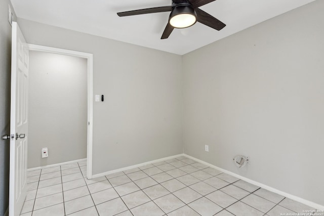 tiled empty room with ceiling fan