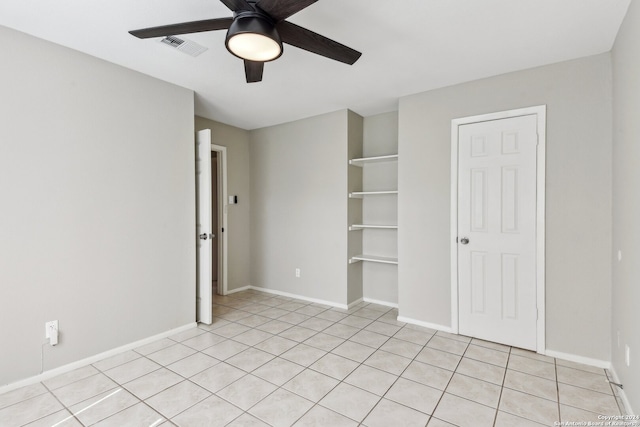 unfurnished bedroom featuring light tile patterned floors and ceiling fan