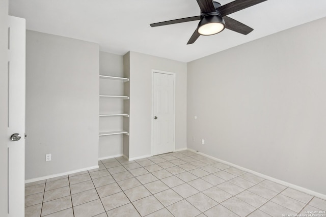 empty room featuring ceiling fan and light tile patterned floors