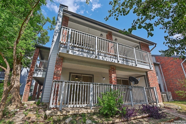 14343 Judson Rd Unit 803, San Antonio, TX 78233 - rear view of house featuring a balcony, covered porch, and brick siding