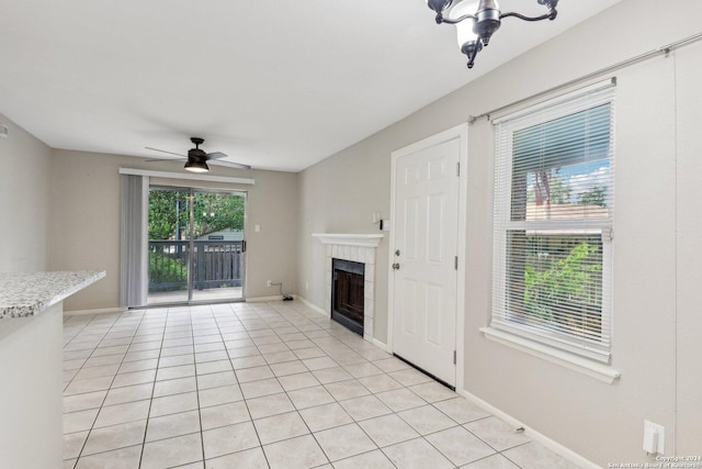 14343 Judson Rd Unit 803, San Antonio, TX 78233 - unfurnished living room with ceiling fan, a fireplace, light tile patterned floors, and baseboards