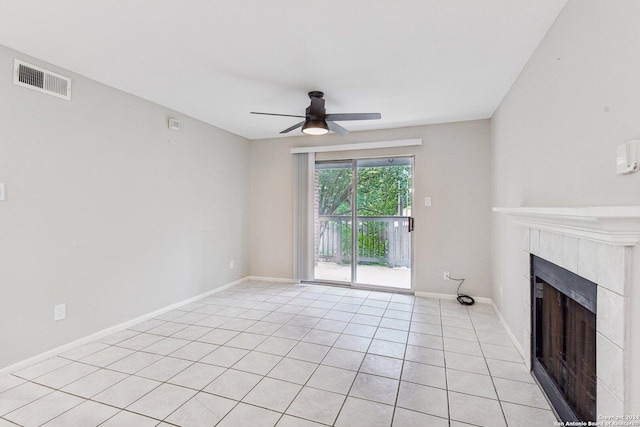 14343 Judson Rd Unit 803, San Antonio, TX 78233 - unfurnished living room featuring a tiled fireplace, ceiling fan, light tile patterned flooring, and baseboards