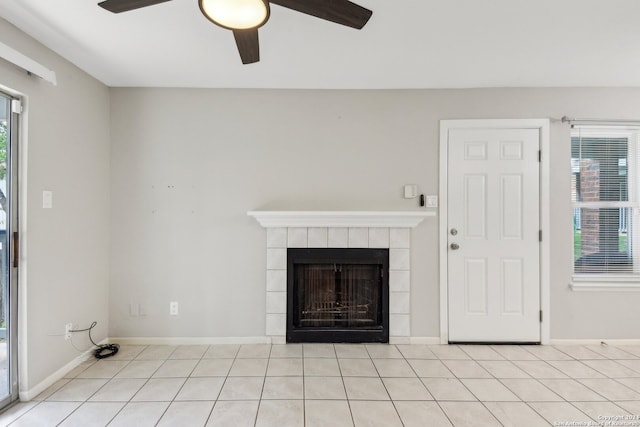 unfurnished living room with a tile fireplace, ceiling fan, and light tile patterned floors