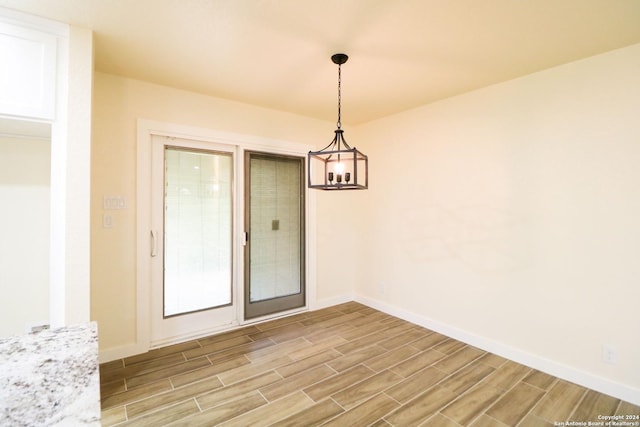 unfurnished dining area featuring a notable chandelier