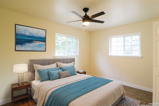 bedroom featuring ceiling fan and dark hardwood / wood-style floors