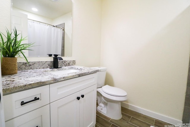 bathroom with toilet and vanity