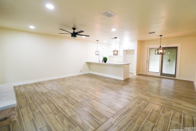 unfurnished living room featuring ceiling fan