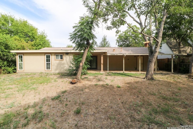 rear view of house with a lawn