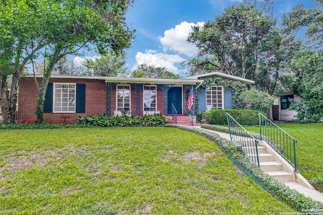 single story home featuring a front lawn