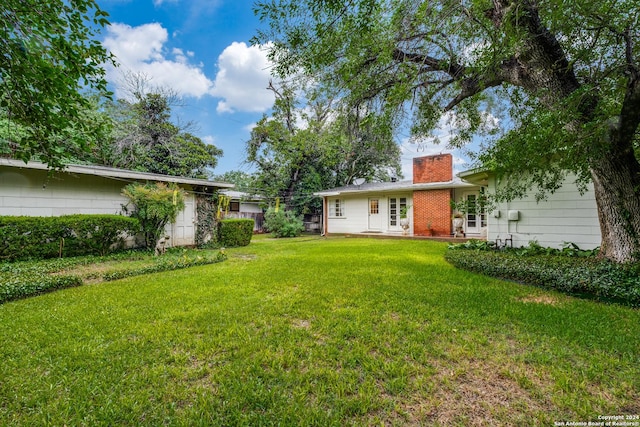 view of yard with french doors