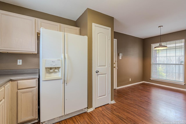 kitchen featuring hanging light fixtures, light brown cabinetry, dark wood-type flooring, and white refrigerator with ice dispenser