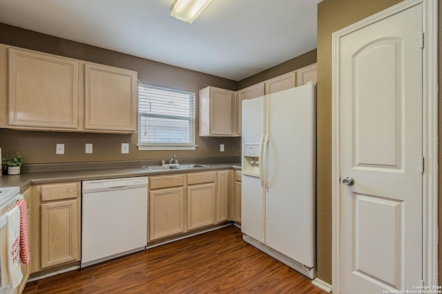 kitchen with light brown cabinetry, dark hardwood / wood-style flooring, sink, and white appliances