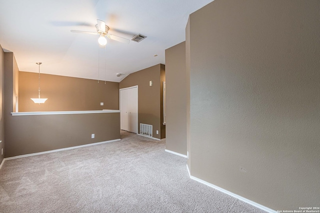 empty room with ceiling fan, carpet, and lofted ceiling