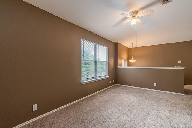 unfurnished room with ceiling fan and carpet flooring