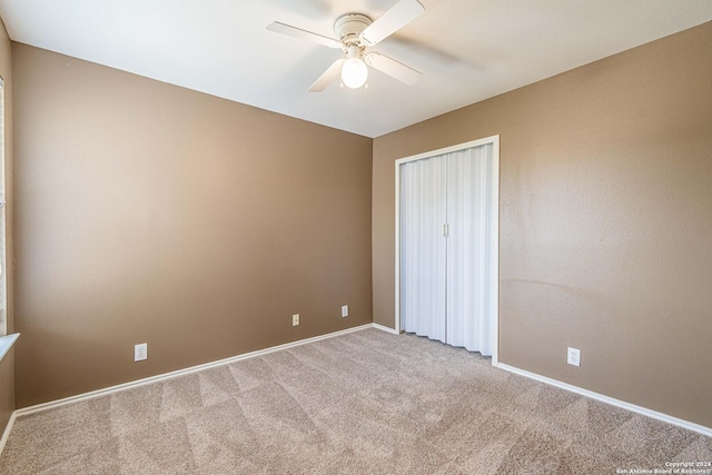 unfurnished bedroom with ceiling fan and light colored carpet