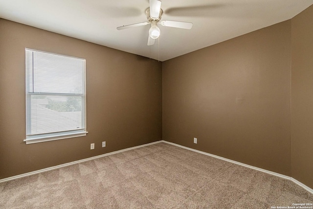 unfurnished room with ceiling fan, light carpet, and a healthy amount of sunlight