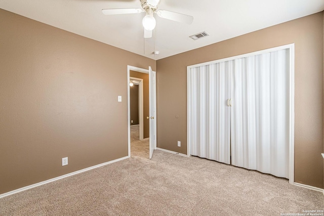 unfurnished bedroom featuring ceiling fan and light carpet