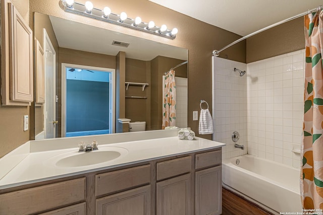 full bathroom with toilet, vanity, and shower / tub combo with curtain