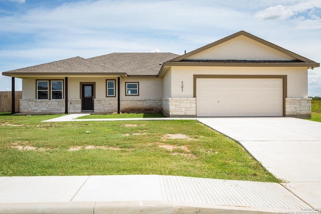 view of front facade featuring a garage and a front lawn