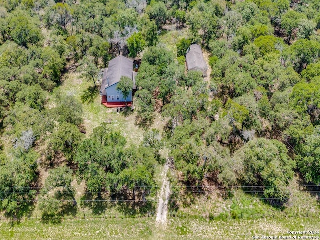 drone / aerial view featuring a wooded view