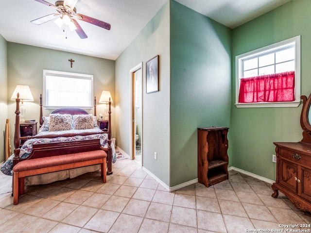 bedroom with light tile patterned flooring, a ceiling fan, and baseboards